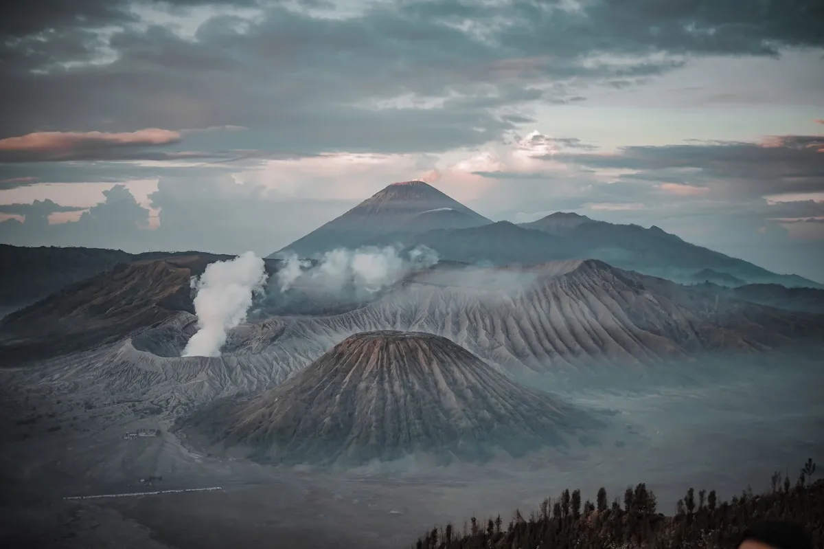 A volcano with smoke coming out of it.