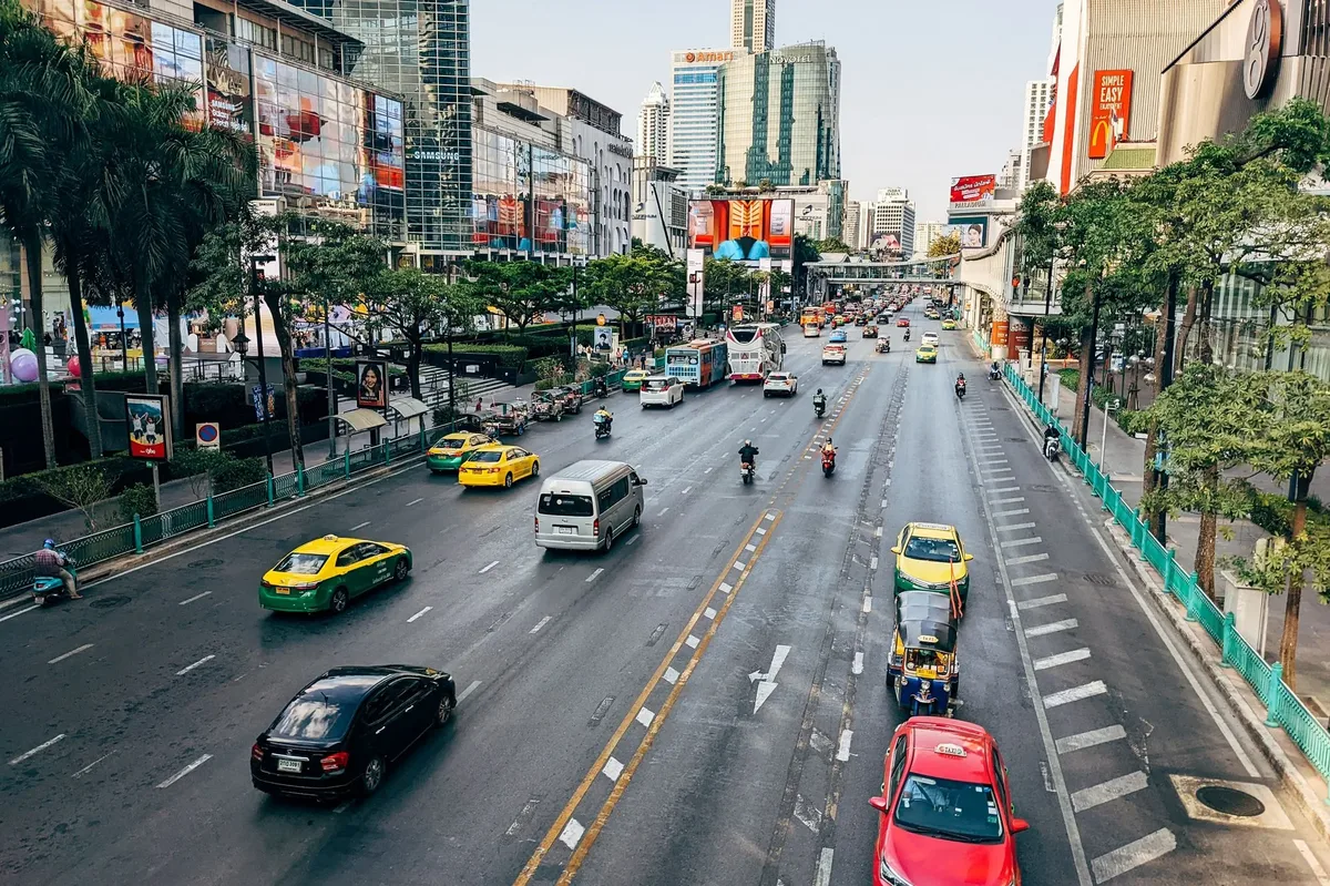 A busy city street with lots of traffic and tall buildings.