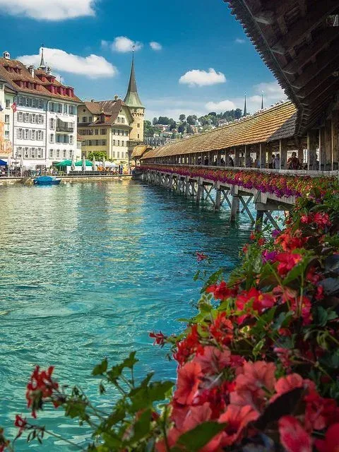 The wooden Chapel Bridge with flower boxes across the river in Lucerne