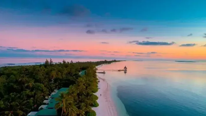 An island coastline at sunset in Addu Atoll