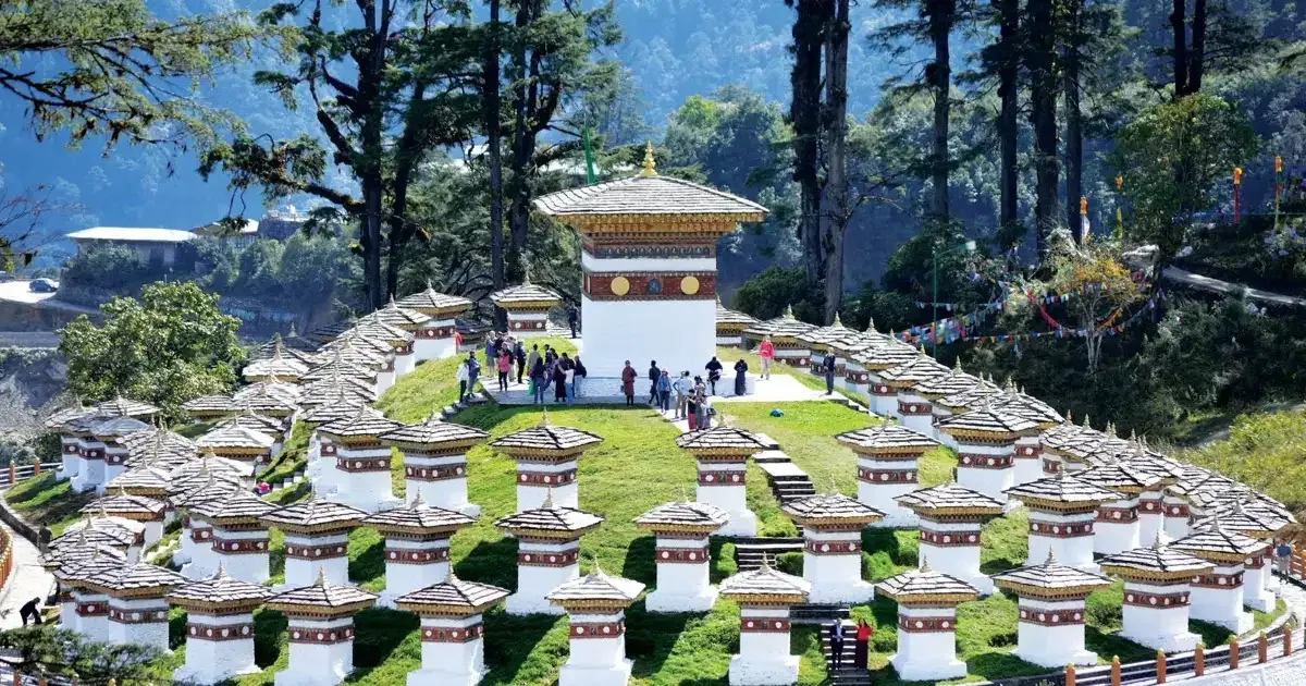 The 108 white chortens of Dochula Pass on a green hill in Bhutan