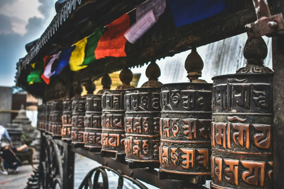 A row of brass prayer wheels in Nepal